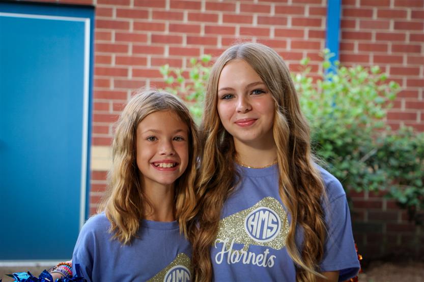 Two students smile